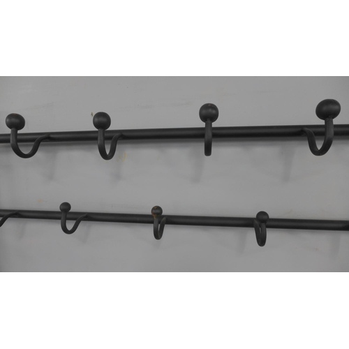 1404 - A black metal tubular hall stand