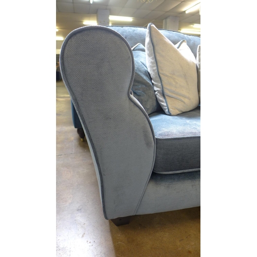 1430 - A diamond blue upholstered four seater sofa