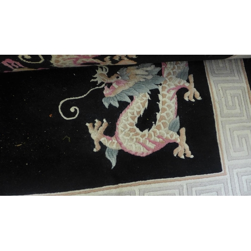 1598 - A set of  three matching black and cream rugs