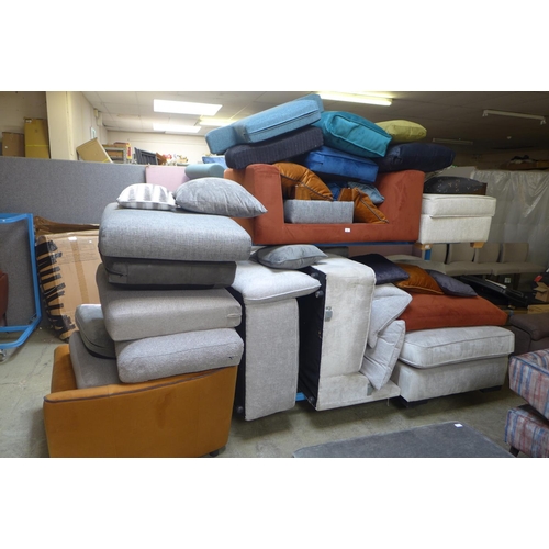 1605 - A miscellaneous lot of sofa parts including end pieces, sections, armchair, footstools and mixed cus... 