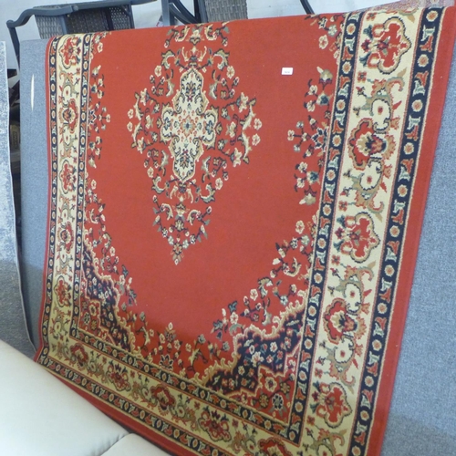 1616 - A red and cream large medallion design rug