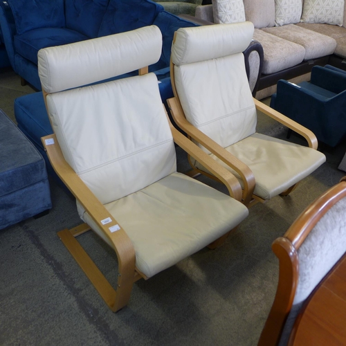 1633 - A pair of cream leather and beech cantilever armchairs