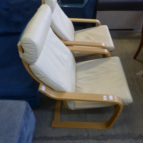 1633 - A pair of cream leather and beech cantilever armchairs