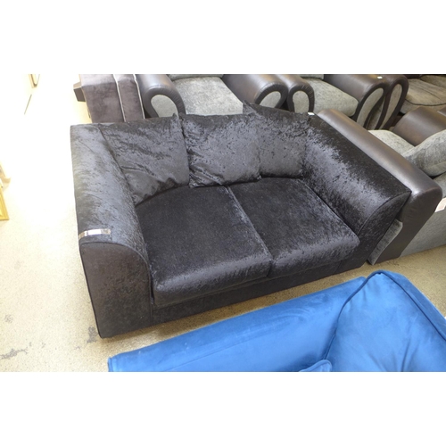 1650 - A black crushed velvet two seater sofa