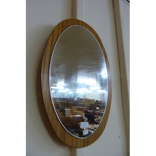 53 - An oval teak framed mirror