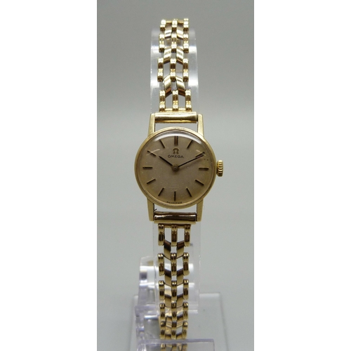 1020 - A lady's 9ct gold Omega wristwatch with gold strap, 15g gross weight