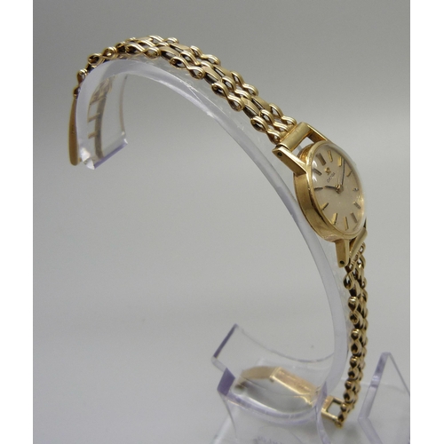 1020 - A lady's 9ct gold Omega wristwatch with gold strap, 15g gross weight