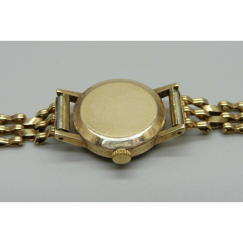 1020 - A lady's 9ct gold Omega wristwatch with gold strap, 15g gross weight