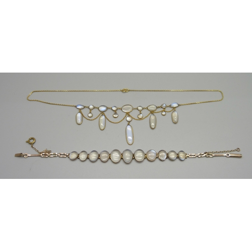 1038 - A 9ct gold and moonstone drop necklace, and a yellow metal moonstone set bracelet with a plated fast... 