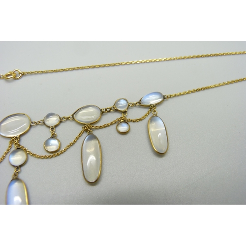 1038 - A 9ct gold and moonstone drop necklace, and a yellow metal moonstone set bracelet with a plated fast... 