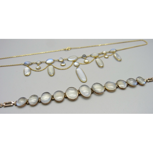 1038 - A 9ct gold and moonstone drop necklace, and a yellow metal moonstone set bracelet with a plated fast... 