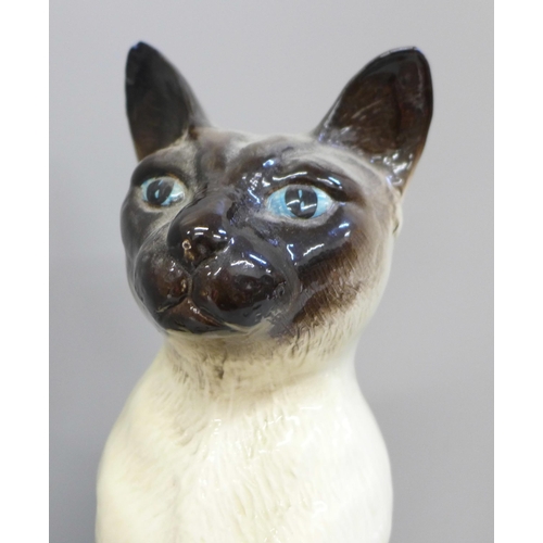 607 - Three Beswick Siamese cats, one large and two medium, largest with chip to ear