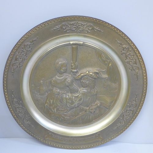 614 - An Arts and Crafts brass dish and a WMF brass embossed plaque