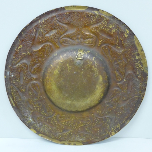 614 - An Arts and Crafts brass dish and a WMF brass embossed plaque