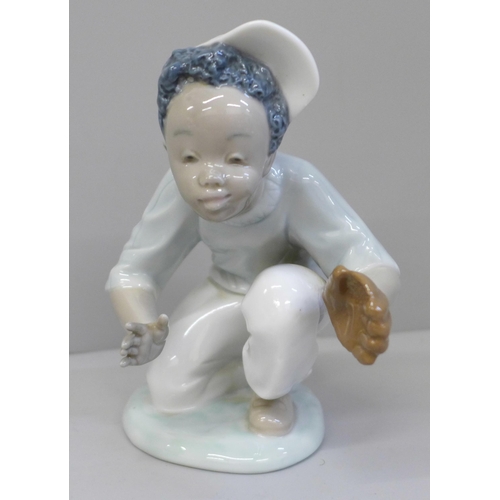 625 - A Lladro figure of a child playing baseball