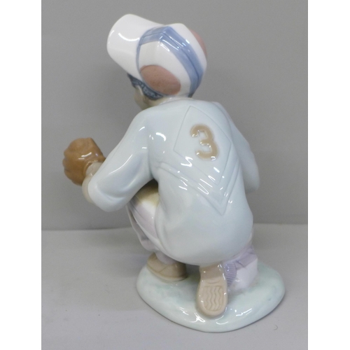 625 - A Lladro figure of a child playing baseball