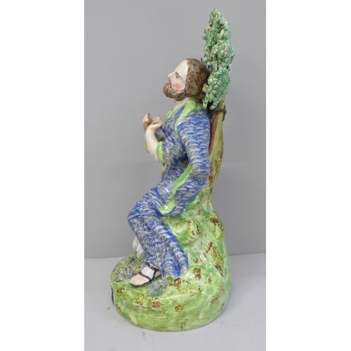 647 - A lead-glazed Staffordshire pearlware figure, titled St. Peter, with bocage, Peter kneels with hands... 