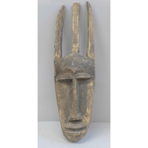 664 - An African carved wooden mask, 44cm