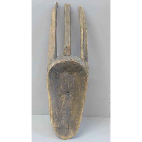 664 - An African carved wooden mask, 44cm