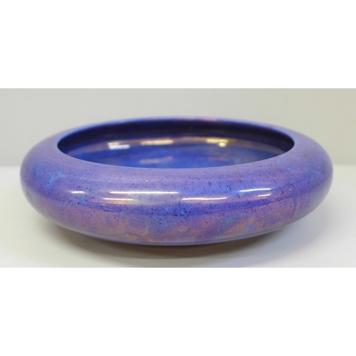 666 - A Moorcroft purple/blue lustre shallow bowl, 20.5cm