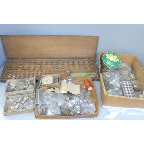 675 - A collection of watch glasses and another box containing trench watch glasses