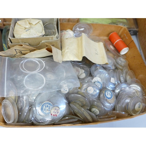 675 - A collection of watch glasses and another box containing trench watch glasses