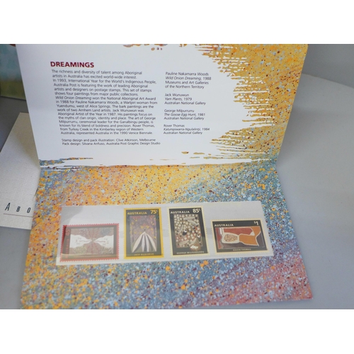 695 - Stamps; a box of stamp albums, covers, presentation packs, etc.