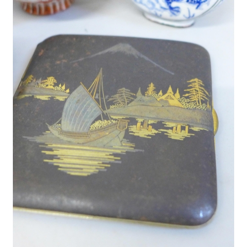 717 - Six oriental items including two netsukes, ginger jar and cigarette case