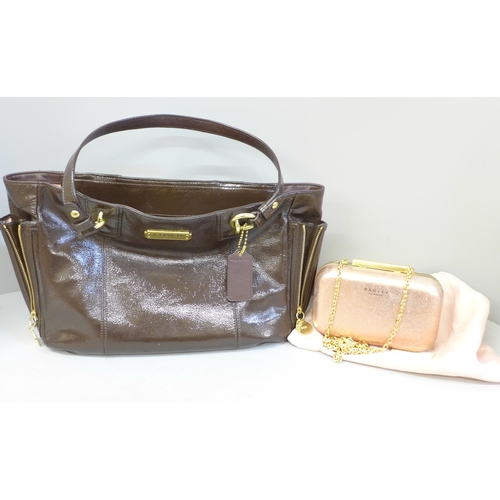 722 - A Coach patent handbag in brown, with pink satin lining, top zip fastening and a variety of pockets ... 