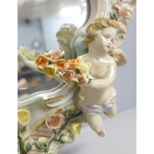 807 - A German porcelain cherub wall mirror