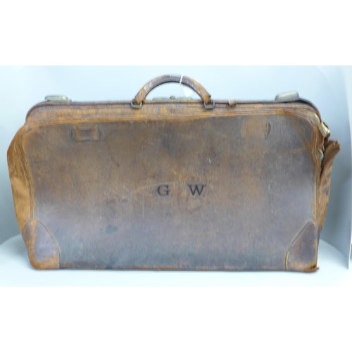 821 - A large leather Gladstone bag marked W.E. Jackson, Drury Hill, Nottingham