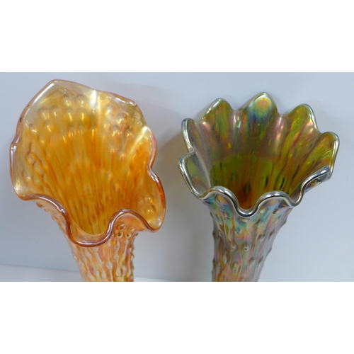 830 - A Northwood iridescent carnival glass tree trunk vase and one other similar in marigold, base chippe... 