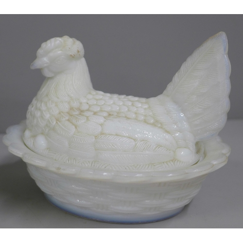 835 - A Westmorland Glass Company iridescent cat on basket and a milk glass hen on basket