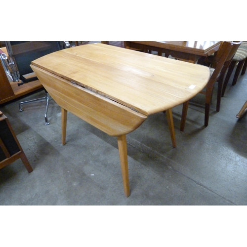 73 - An Ercol Blonde elm and beech drop leaf table