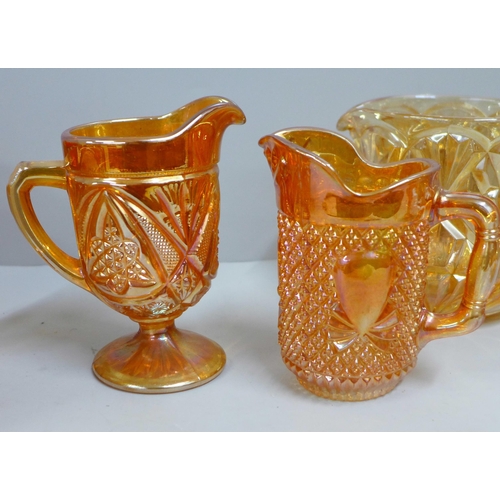 854 - Ten items of marigold carnival glass, five jugs/pitchers, two pedestal bowls, other bowls including ... 