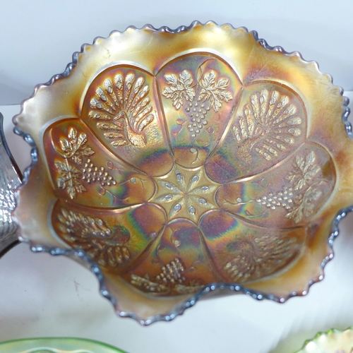 864A - Five items of carnival glass including a Northwood ruffled stippled ray bowl and an amber peacock an... 