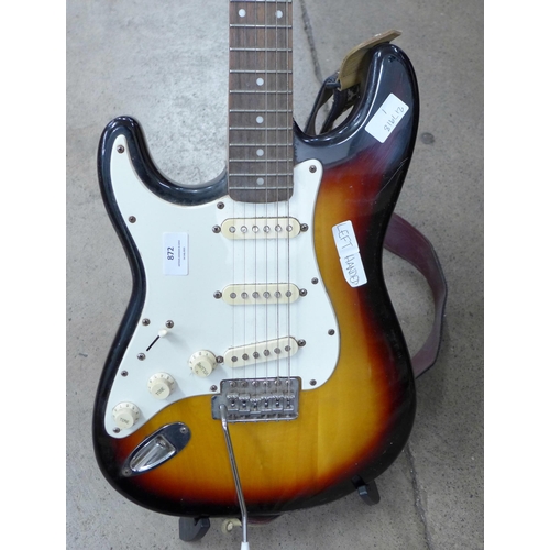 872 - A left handed Fender Squier Strat guitar and stand