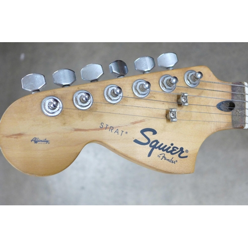 872 - A left handed Fender Squier Strat guitar and stand