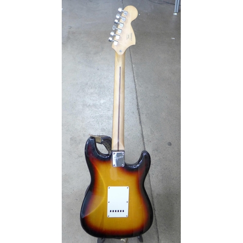 872 - A left handed Fender Squier Strat guitar and stand