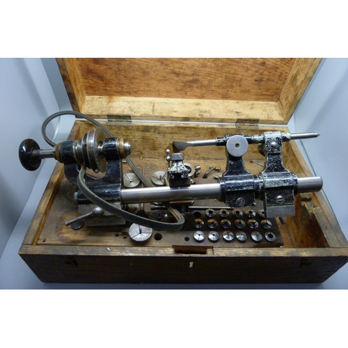 888 - A watchmaker's lathe, 8mm with collets and step chucks, cased