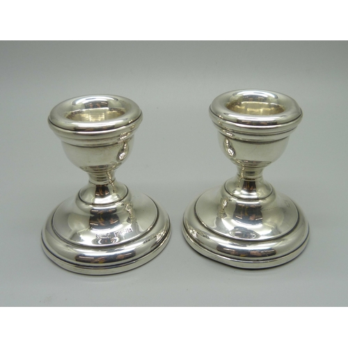 892 - A silver topped Walker & Hall claret jug, and a pair of silver candlesticks