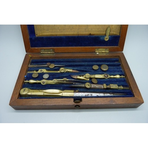 909 - A technical drawing set in a wooden case, some instruments missing