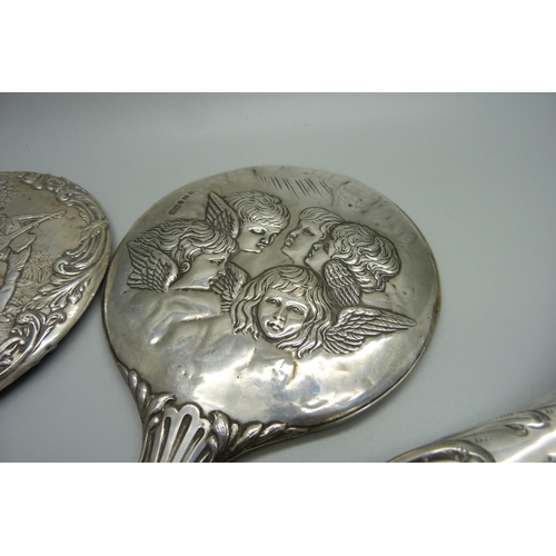 938 - Silver backed brushes and mirrors including two embossed with Reynolds Angels, one brush silver plat... 