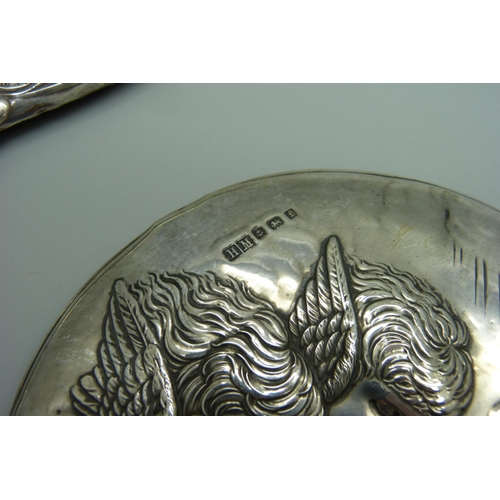 938 - Silver backed brushes and mirrors including two embossed with Reynolds Angels, one brush silver plat... 