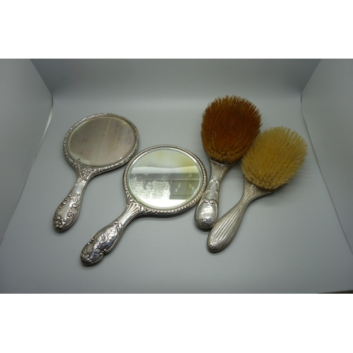 938 - Silver backed brushes and mirrors including two embossed with Reynolds Angels, one brush silver plat... 