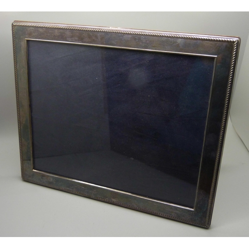 951 - A silver photograph frame, 30cm x 25cm approximate