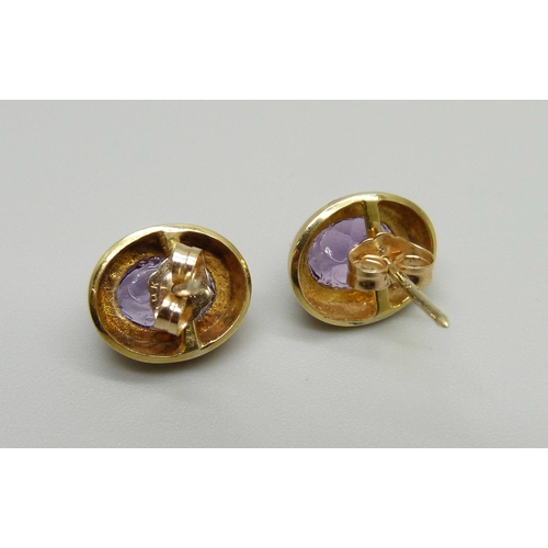 956 - A pair of 9ct gold and amethyst ear studs, with butterflies marked 14k, 2.7g