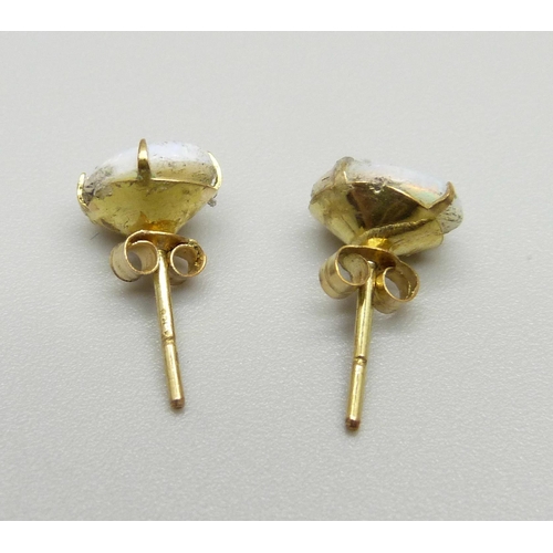 957 - A pair of 9ct gold and opal ear studs, opals scratched, 0.8g