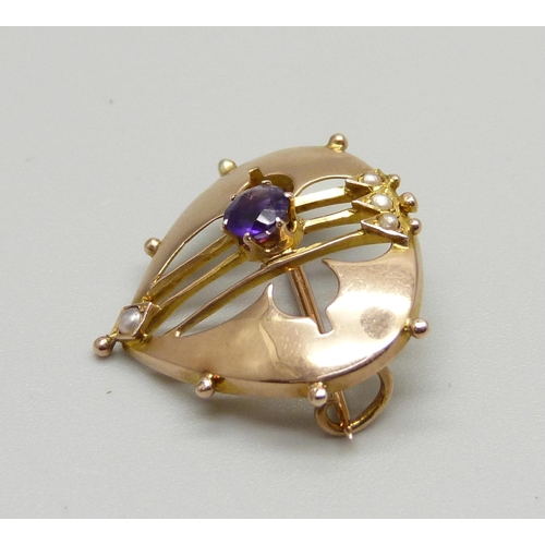 964 - A 9ct gold Arts and Crafts brooch set with an amethyst and seed pearls, makers mark H.H, Birmingham ... 