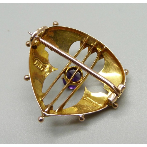 964 - A 9ct gold Arts and Crafts brooch set with an amethyst and seed pearls, makers mark H.H, Birmingham ... 